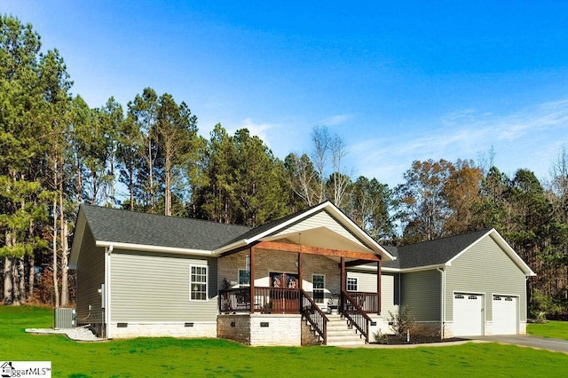 view of front facade featuring a porch, a garage, a front lawn, and central air condition unit