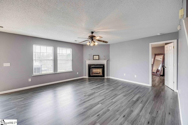 unfurnished living room with wood-type flooring, a textured ceiling, and ceiling fan