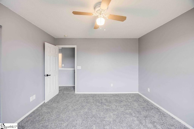 carpeted empty room featuring ceiling fan