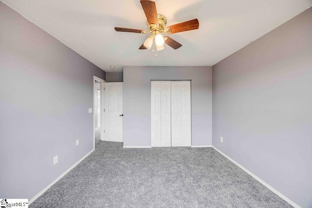 unfurnished bedroom with ceiling fan, a closet, and carpet floors