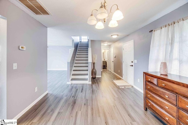 interior space featuring a notable chandelier and light wood-type flooring