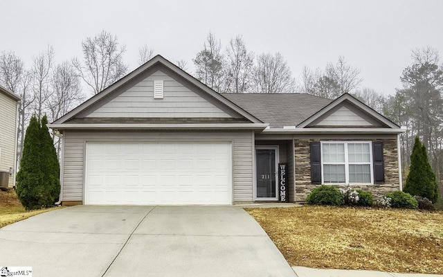 view of front of house with central AC unit and a garage