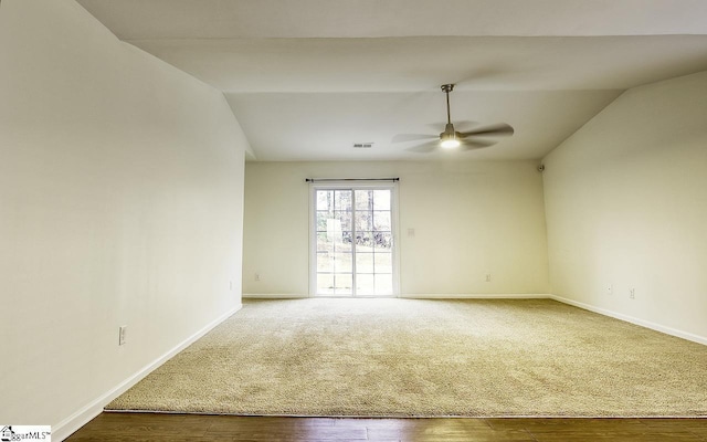 empty room with hardwood / wood-style floors, ceiling fan, and lofted ceiling