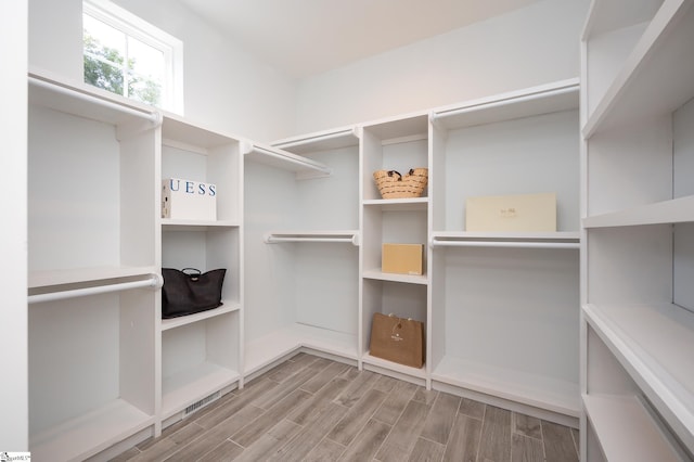 spacious closet featuring light hardwood / wood-style flooring