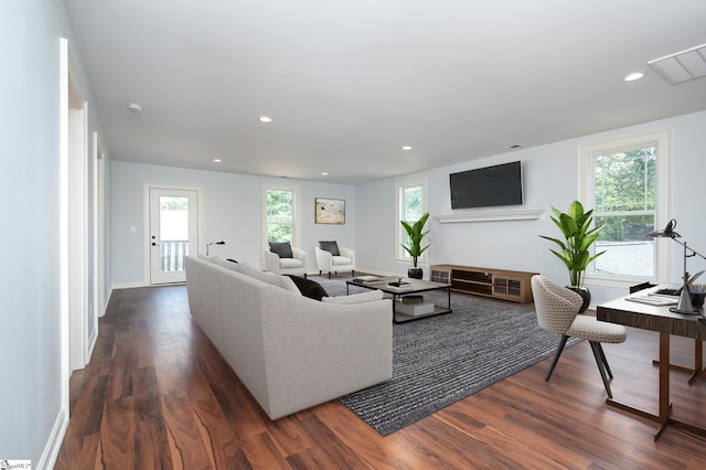 living room featuring dark hardwood / wood-style flooring and plenty of natural light