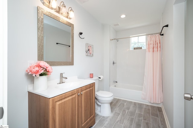 full bathroom featuring hardwood / wood-style floors, vanity, toilet, and shower / tub combo