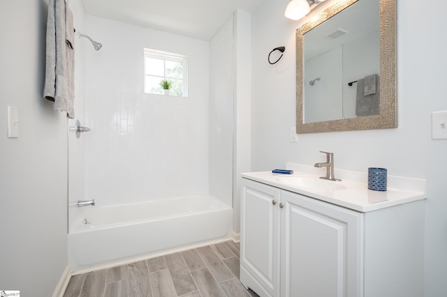 bathroom with hardwood / wood-style flooring, vanity, and shower / bathing tub combination