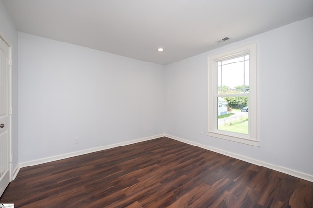 unfurnished room with dark hardwood / wood-style flooring