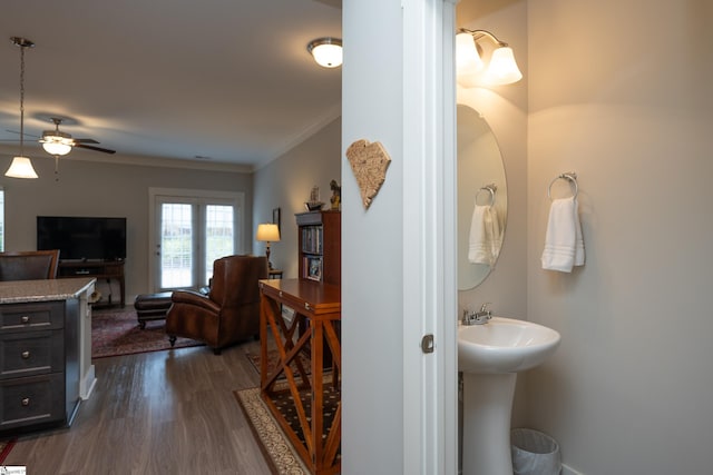 bathroom featuring ceiling fan, wood-type flooring, and crown molding