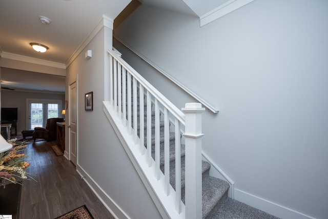 stairway featuring hardwood / wood-style floors and ornamental molding