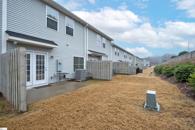 rear view of house featuring a patio area and central AC unit