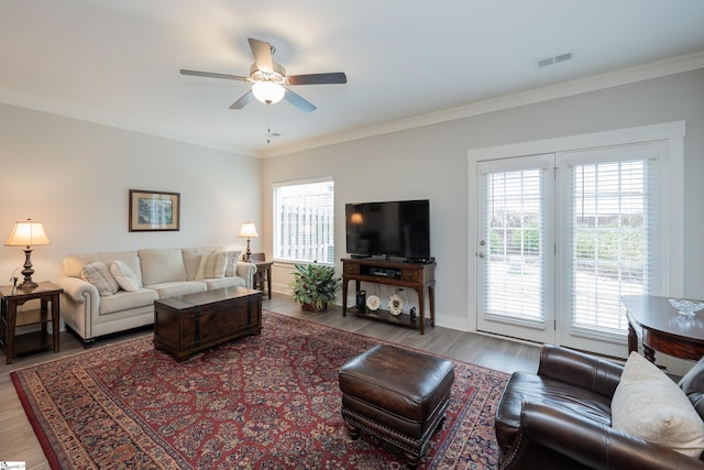 living room featuring ceiling fan, wood-type flooring, and ornamental molding