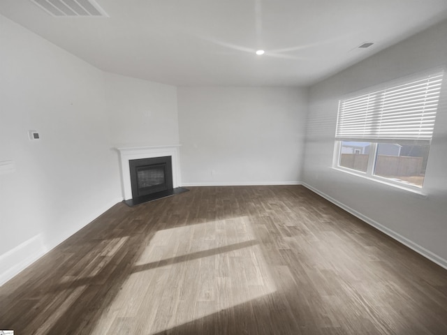 unfurnished living room with dark hardwood / wood-style flooring