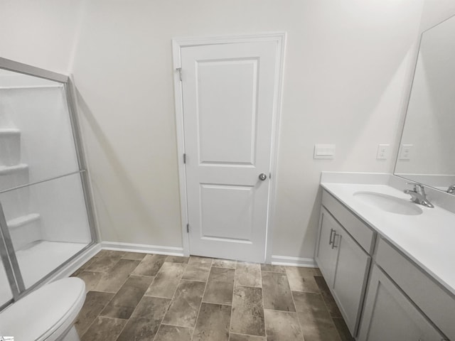 bathroom featuring hardwood / wood-style floors, vanity, and a shower with shower door