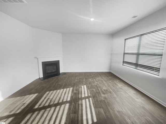 unfurnished living room with dark wood-type flooring