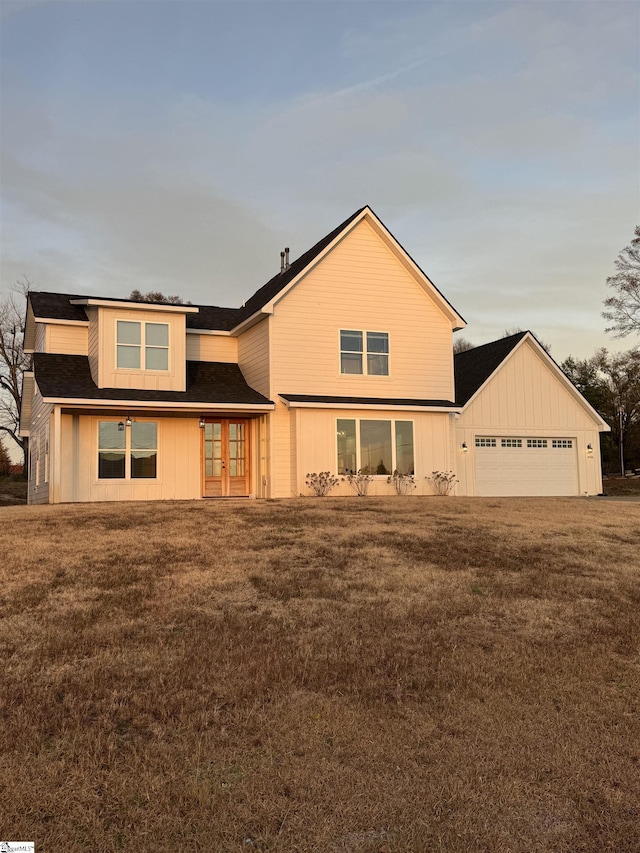 view of front of property with a garage and a front yard