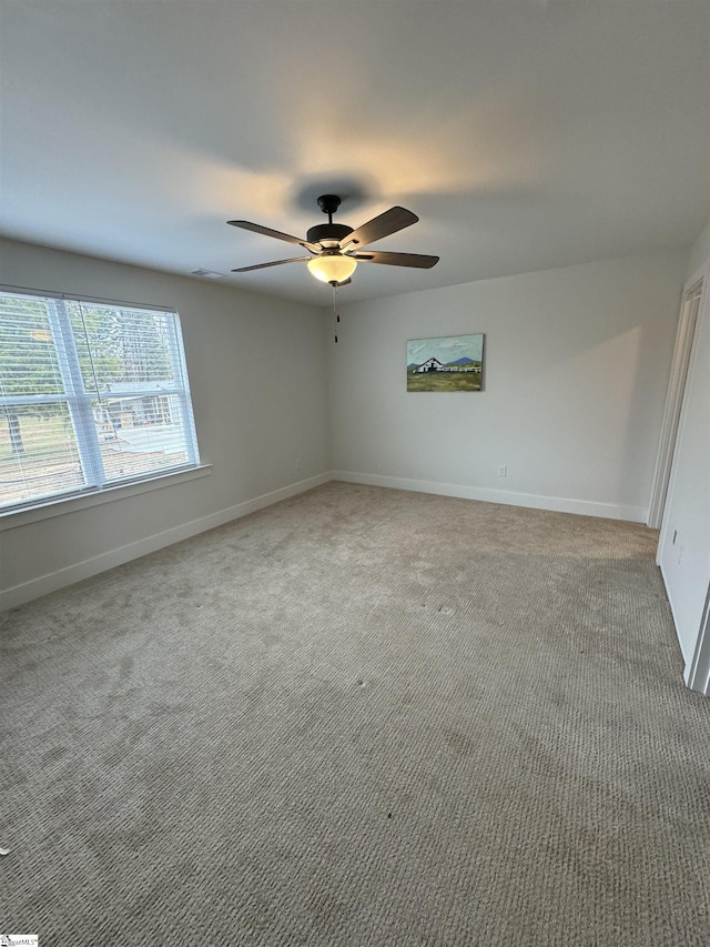 spare room with carpet flooring and ceiling fan