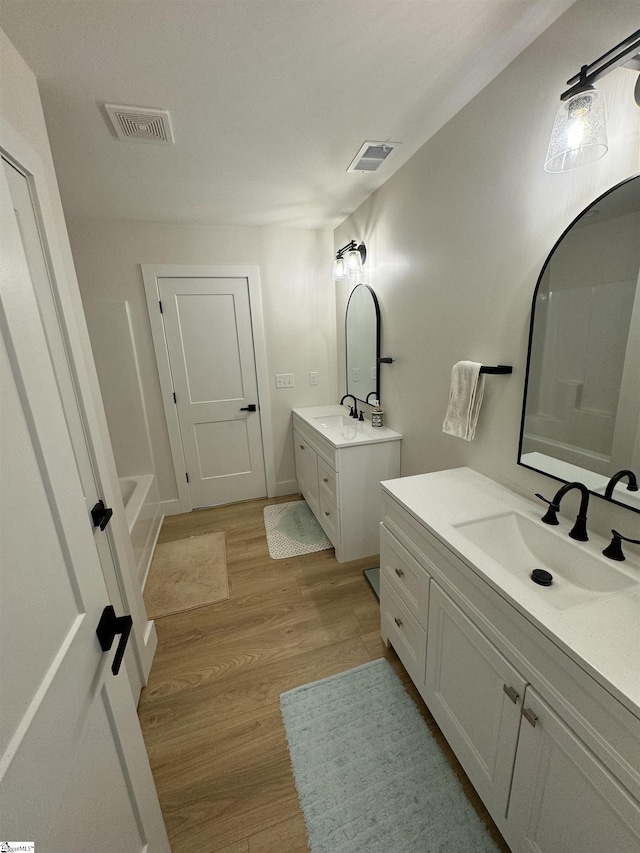 bathroom featuring vanity and hardwood / wood-style floors