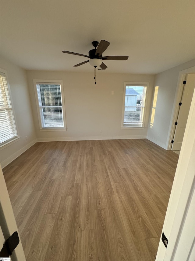 empty room with ceiling fan and light wood-type flooring