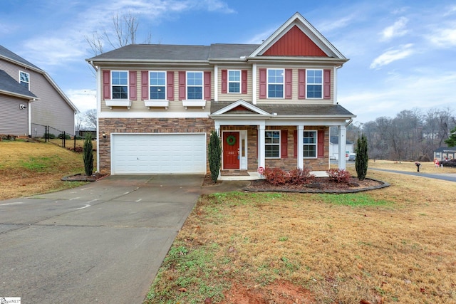 view of front of property with a front yard and a garage