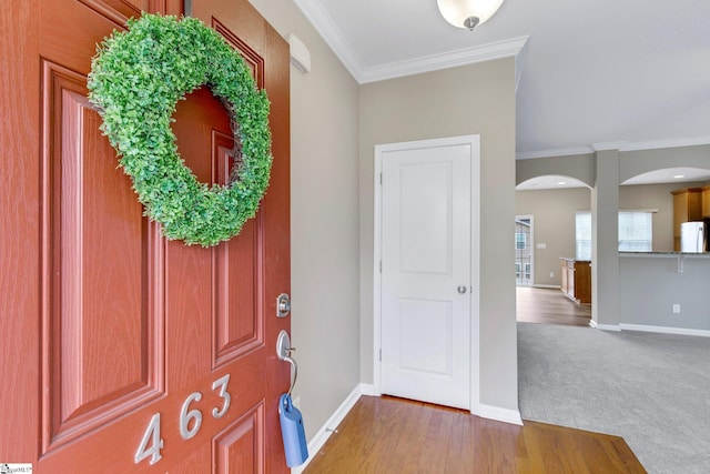 foyer featuring crown molding and wood-type flooring