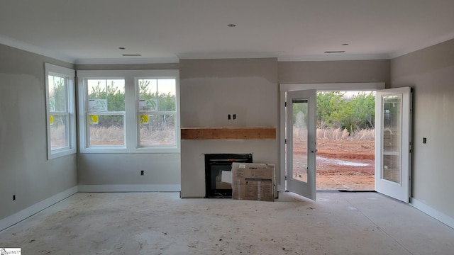 unfurnished living room with french doors, a fireplace, and crown molding