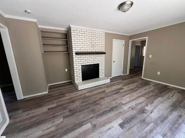 unfurnished living room with a fireplace, crown molding, and dark wood-type flooring