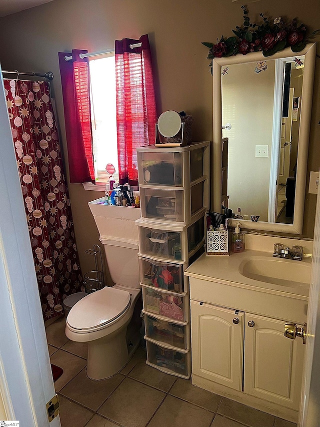 bathroom featuring a shower with curtain, tile patterned flooring, vanity, and toilet