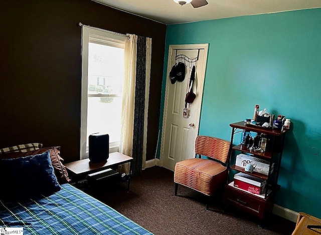 bedroom with dark colored carpet and ceiling fan