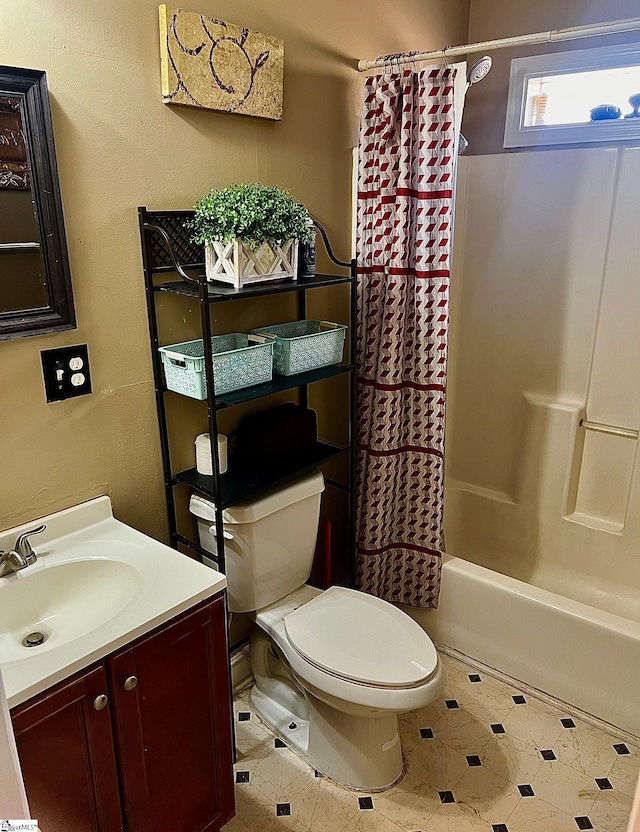 full bathroom featuring tile patterned floors, vanity, toilet, and shower / bath combo with shower curtain