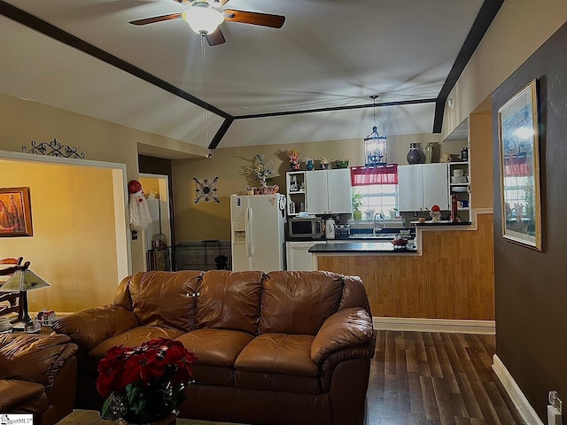 living room with lofted ceiling, wooden walls, ceiling fan, and dark hardwood / wood-style floors