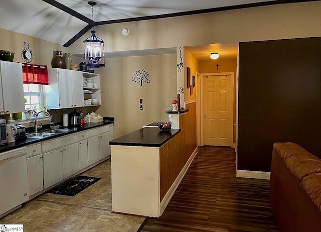 kitchen featuring white dishwasher, vaulted ceiling, sink, an inviting chandelier, and white cabinetry