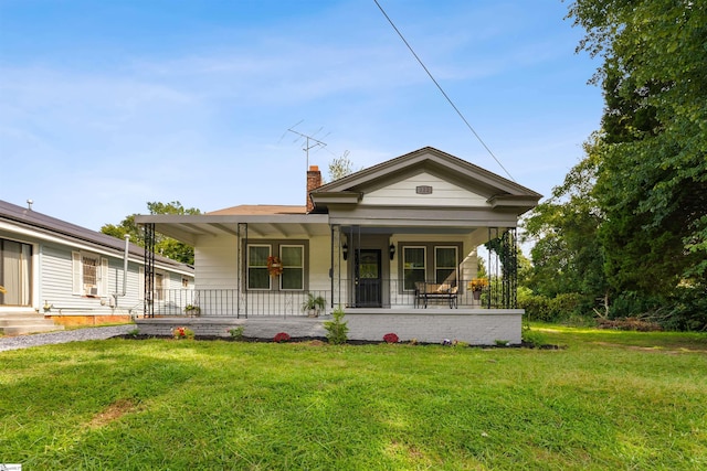 view of front of home featuring a porch and a front lawn