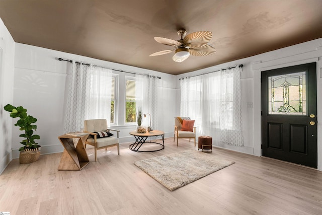 sitting room featuring plenty of natural light, ceiling fan, and light hardwood / wood-style flooring