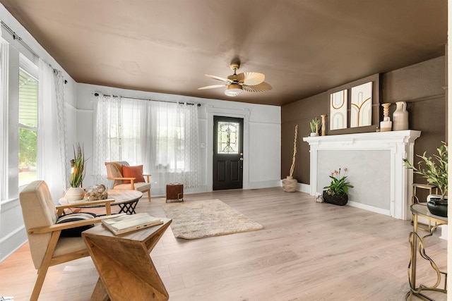 sitting room featuring ceiling fan and light hardwood / wood-style floors