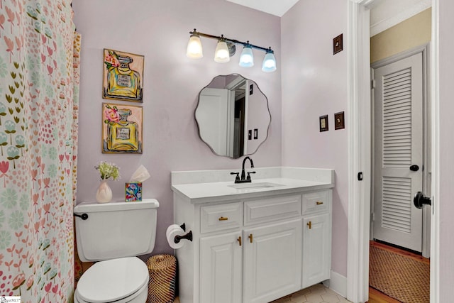 bathroom featuring vanity and toilet