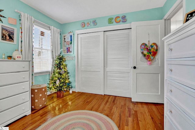 bedroom featuring light hardwood / wood-style flooring and a closet