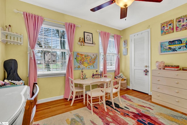 rec room with light hardwood / wood-style flooring and ceiling fan