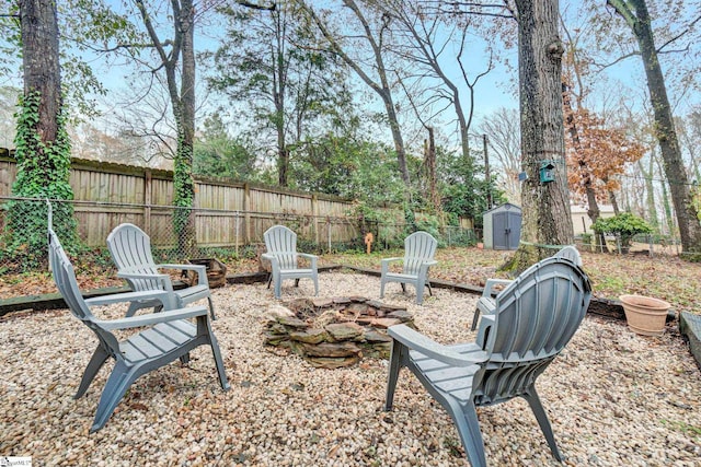 view of yard featuring a storage unit and an outdoor fire pit