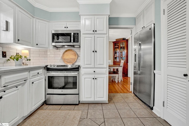 kitchen featuring white cabinetry, light tile patterned flooring, and appliances with stainless steel finishes