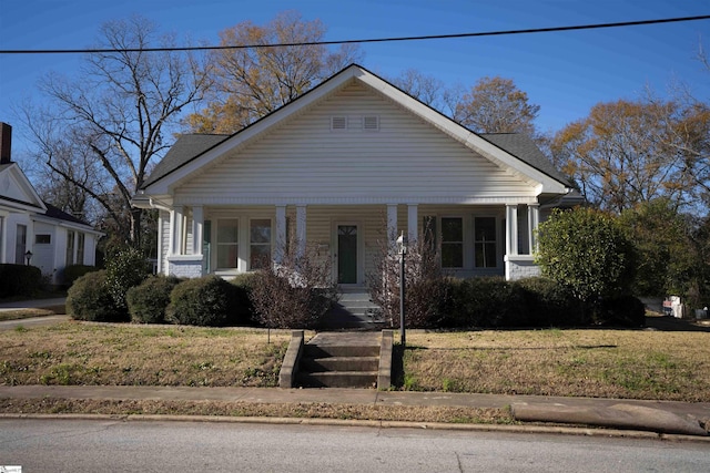 bungalow-style house with covered porch and a front yard