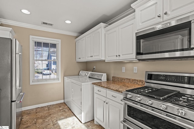 kitchen featuring washer and dryer, appliances with stainless steel finishes, white cabinetry, and crown molding