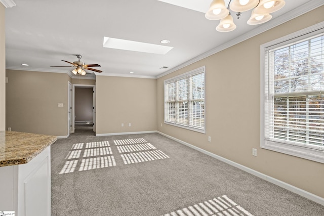 unfurnished living room featuring carpet, a wealth of natural light, and a skylight