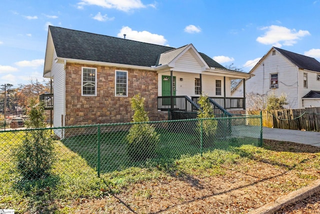 view of front of house with covered porch and a front yard