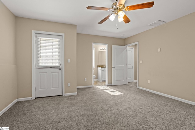 unfurnished bedroom with connected bathroom, light colored carpet, and ceiling fan