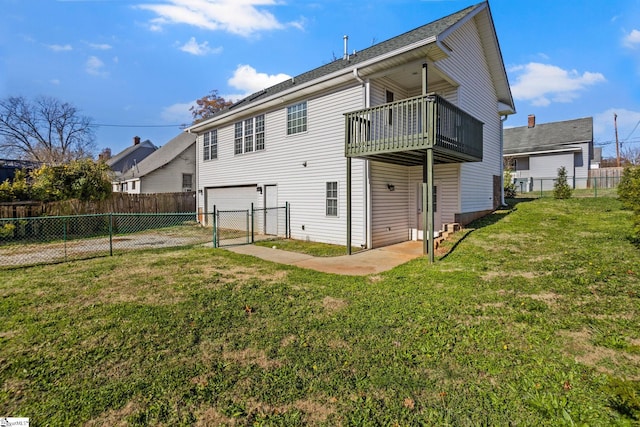 back of house featuring a balcony and a lawn