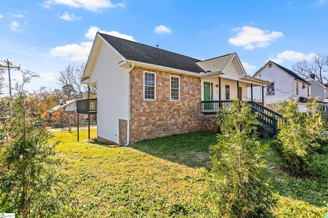 exterior space featuring covered porch and a front yard