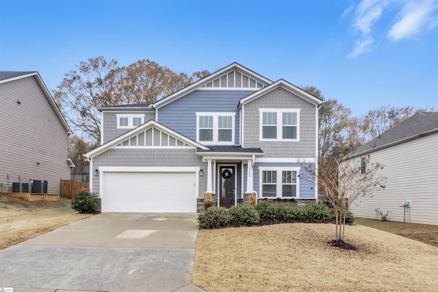 craftsman inspired home featuring a garage and central AC unit