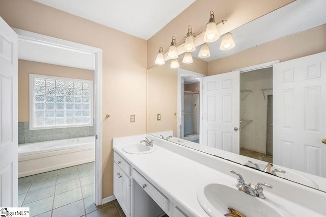 bathroom with tile patterned floors, vanity, and a bathtub