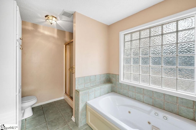 bathroom featuring toilet, a textured ceiling, tile patterned floors, and plus walk in shower